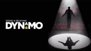 A poster for Dynamo with a man standing in front of a spotlight, levitating off the stage.
